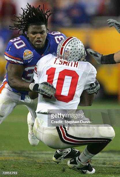 Linebacker Earl Everett of the Florida Gators tackles Troy Smith of the Ohio State Buckeyes after losing his helmet during the 2007 Tostitos BCS...