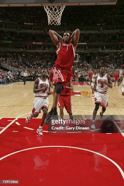 Tracy McGrady of the Houston Rockets goes up for a dunk past Ben Gordon and Luol Deng of the Chicago Bulls during the NBA game on January 8, 2007 at...