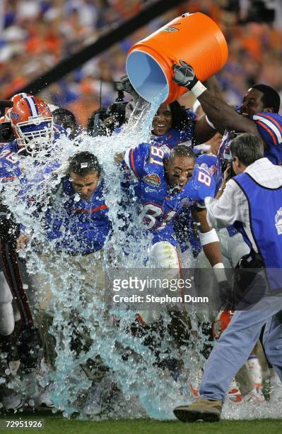Head coach Urban Meyer of the Florida Gators is dowsed with the Gatorade bucket seconds before defeating the Ohio State Buckeyes during the fourth...