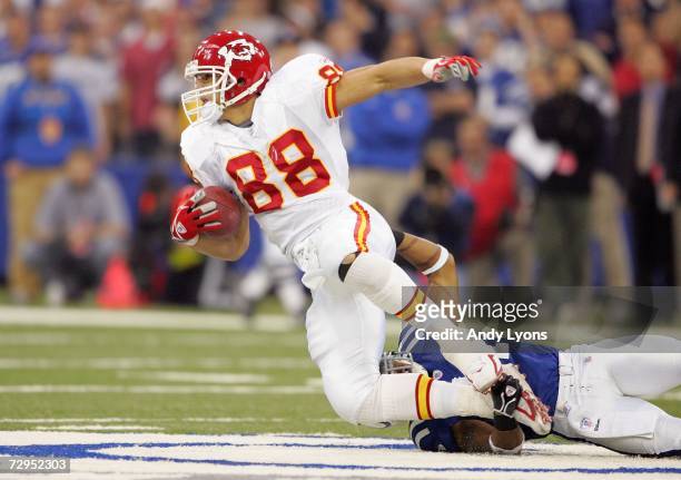 Tight end Tony Gonzalez of the Kansas City Chiefs is tackled by Antoine Bethea of the Indianapolis Colts during their AFC Wild Card Playoff Game...