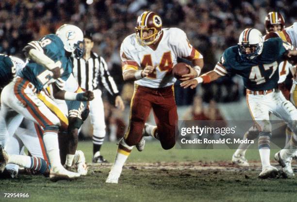 John Riggins of the Washington Redskins carries the ball during Super Bowl XVII against the Miami Dolphins on January 30, l983 in Pasadena,...