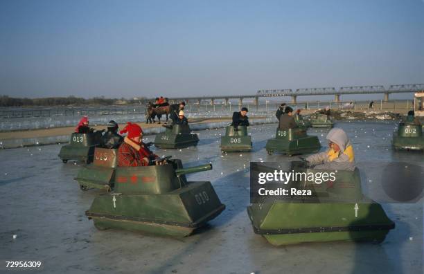 Children play in small tanks on an ice rink made on the frozen Songhua River in Harbin on February, 1999 in Harbin, China.