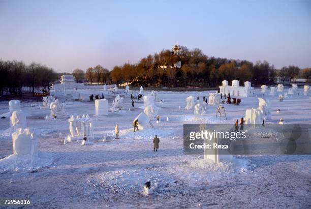 Artists work on snow sculptures, in Sun Island Park during the Ice and Snow Festival celebrating Chinese New Year on February, 1999 in Harbin, China.