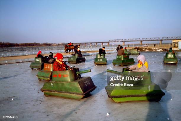 Children play in small tanks on an ice rink made on the frozen Songhua River in Harbin on February, 1999 in Harbin, China.