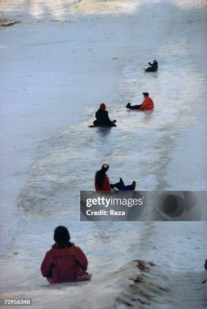 Children play by the frozen Amur River on February, 1999 in Heihe, China.