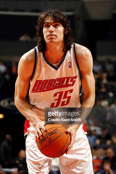 Adam Morrison of the Charlotte Bobcats shoots a free throw against the Boston Celtics at the Charlotte Bobcats Arena on December 16, 2006 in...