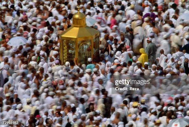 Worshippers surround the Maqam Ibrahim, a small shrine holding a stone which claims to retain the permanent footprint of Abraham, in the Masjid...