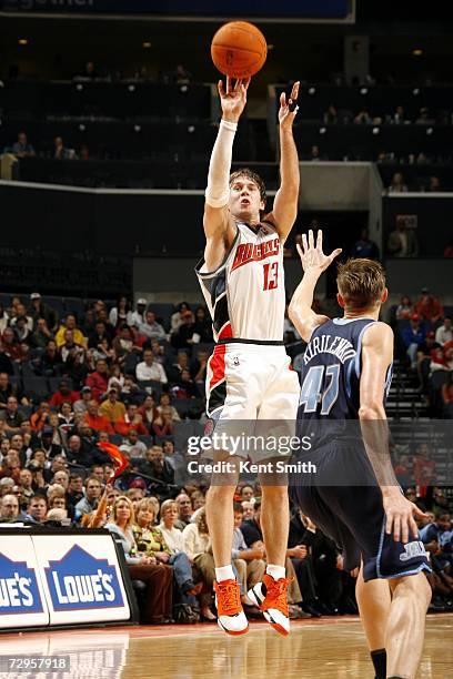 Matt Carroll of the Charlotte Bobcats shoots over Andrei Kirilenko of the Utah Jazz on December 22, 2006 at the Charlotte Bobcats Arena in Charlotte,...