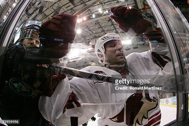 Ed Jovanovski of the Phoenix Coyotes misses the check against Jeff Halpern of the Dallas Stars at the American Airlines Center January 9, 2007 in...