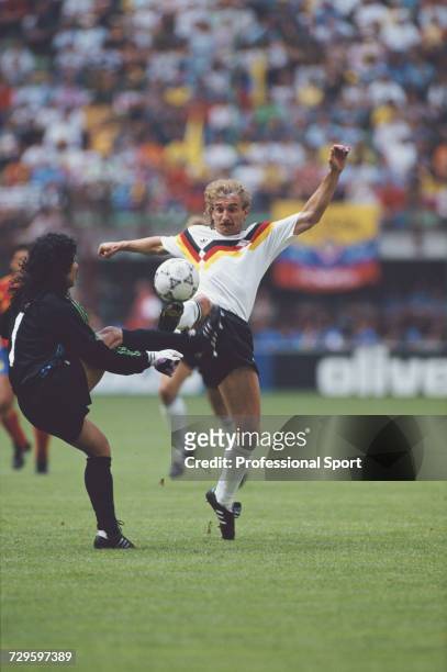 German footballer Rudi Voller clashes with Colombian goalkeeper Rene Higuita in the Group D match between West Germany and Colombia in the 1990 FIFA...