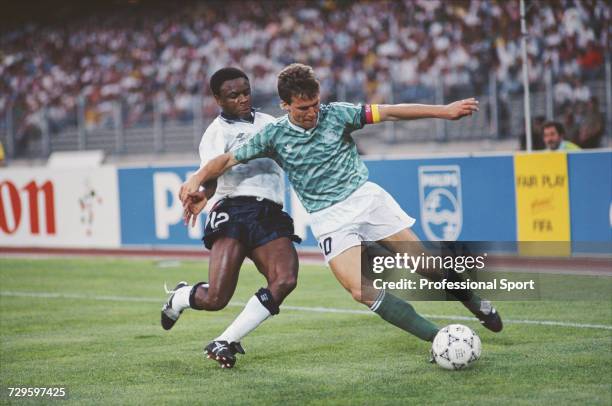 English footballer Paul Parker moves in to tackle West Germany captain Lothar Matthaus during the semi final match between West Germany and England...