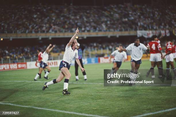 English footballer Mark Wright raises one arm in the air in celebration after scoring a goal for England in their Group F match against Egypt in the...