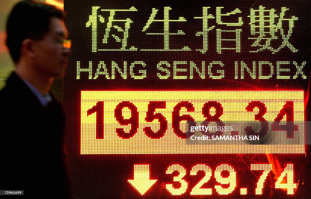 A man walk past a electric board display