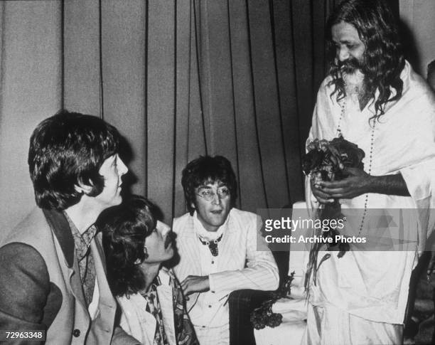 Paul McCartney, George Harrison and John Lennon of the Beatles, backstage with the Maharishi Mahesh Yogi after he gave a lecture on transcendental...