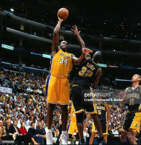Shaquille O'Neal of the Los Angeles Lakers attempts a shot against Dale Davis of the Indiana Pacers during Game Six of the 2000 NBA Finals on June...
