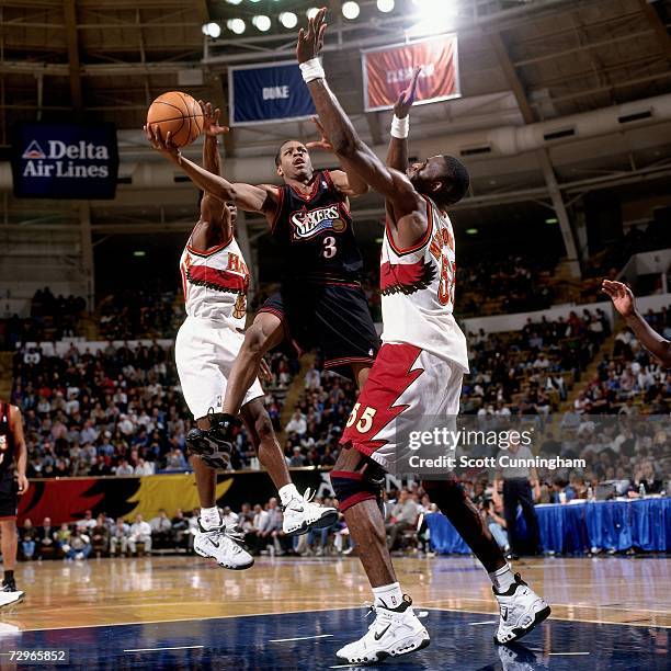 Allen Iverson of the Philadelphia 76ers attempts a layup against Dikembe Mutombo of the Atlanta Hawks during a 1998 NBA Game played at the Phillips...