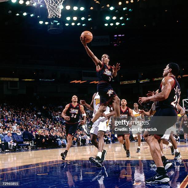 Allen Iverson of the Philadelphia 76ers attempts a layup against the Golden State Warriors during a 1998 NBA Game played at the Arena in Oakland,...