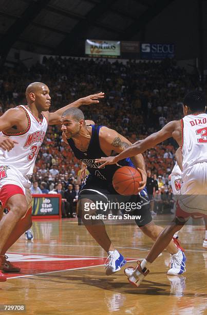 Carlos Boozer of the Duke Blue Devils takes the ball to the basket as he is blocked by Lonny Baxter of the Maryland Terrapins at the Cole Field House...