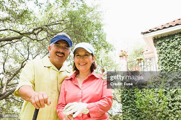 married couple outside their home - golf club house stock pictures, royalty-free photos & images