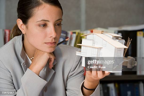 female architect looking at an architectural model - gray shirt mockup stock pictures, royalty-free photos & images