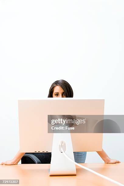 woman standing behind monitor - hiding behind back stock pictures, royalty-free photos & images