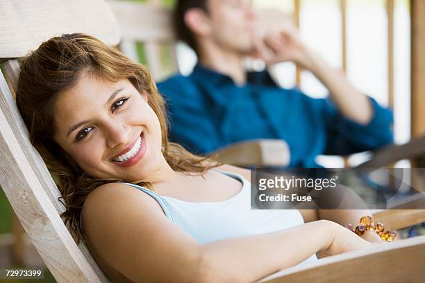 couple relaxing - adirondack chair closeup stock pictures, royalty-free photos & images