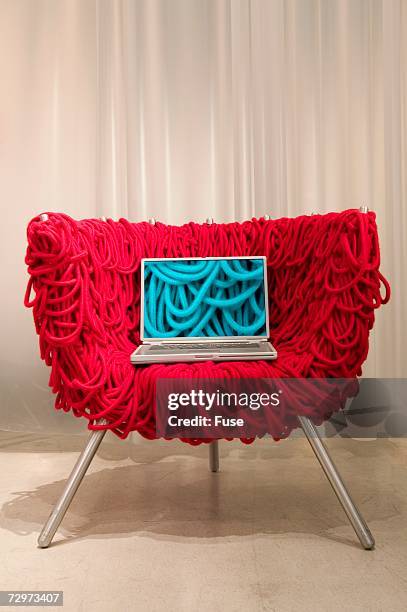 red chair with laptop - fab fragment stockfoto's en -beelden