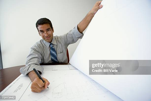 businessman with blueprints - rolled up sleeves drawing stock pictures, royalty-free photos & images