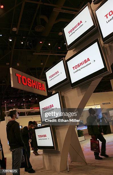 Attendees walk through the Toshiba booth at the Las Vegas Convention Center during the 2007 International Consumer Electronics Show January 10, 2007...