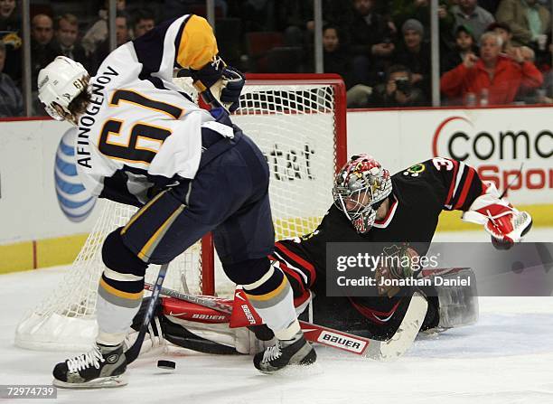 Goalie Nikolai Khabibulin of the Chicago Blackhawks makes a save against Maxim Afinogenov of the Buffalo Sabres January 10, 2007 at the United Center...