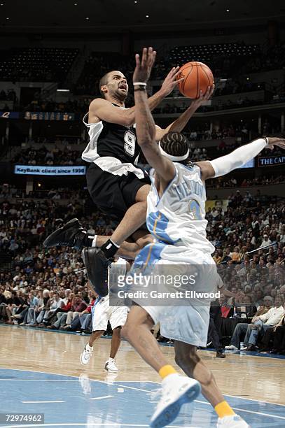 Tony Parker of the San Antonio Spurs drives to the basket against Allen Iverson of the Denver Nuggets on January 10, 2007 at the Pepsi Center in...