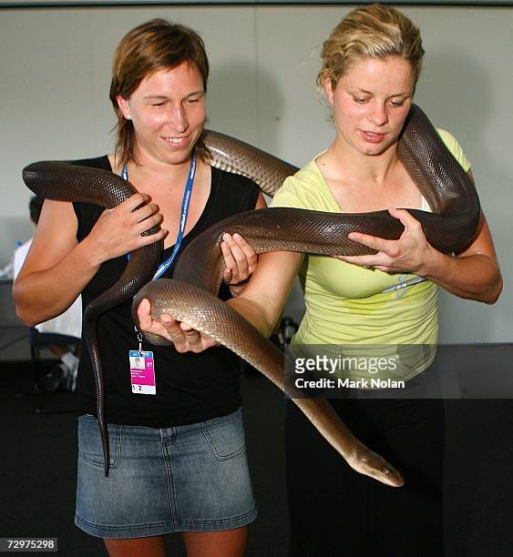 Caroline Maes and Kim Clijsters of Belgium hold a four meter long Olive Python on day five of the 2007 Medibank International at the Sydney...