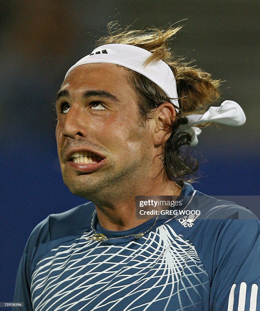 Marcos Baghdatis of Cyprus pulls a stran