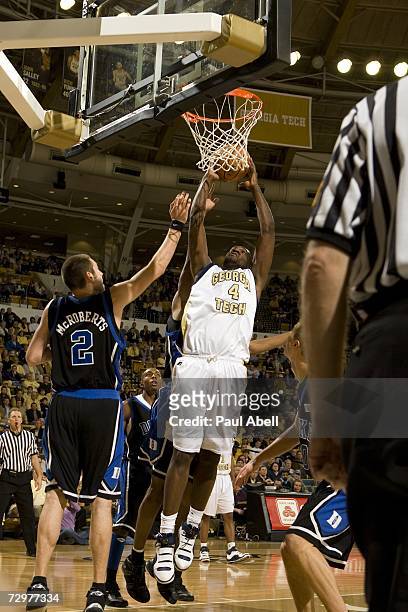 Center Ra'Sean Dickey of the Georgia Tech Yellow Jackets drives the ball to the basket against forward/center Josh McRoberts of the Duke Blue Devils...