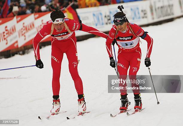 Frode Andresen of Norway changes with his team mate Ole Einar Bjoerndalen during the men's 4x7.5 km relay in the Biathlon World Cup on January 11,...