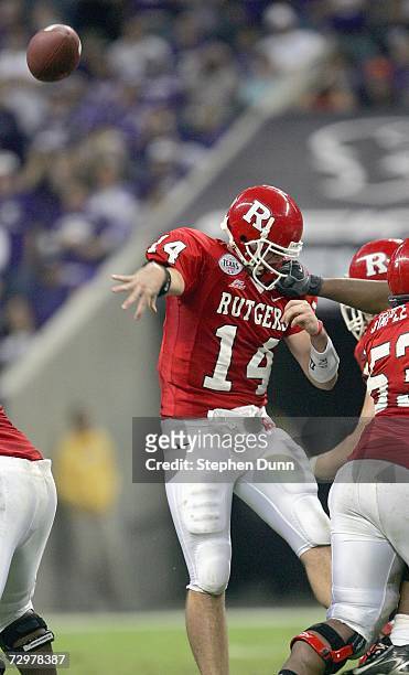 Quarterback Mike Teel of the Rutgers Scarlet Knights throws the pass as he gets a facemask against the Kansas State Wildcats during the Texas Bowl on...