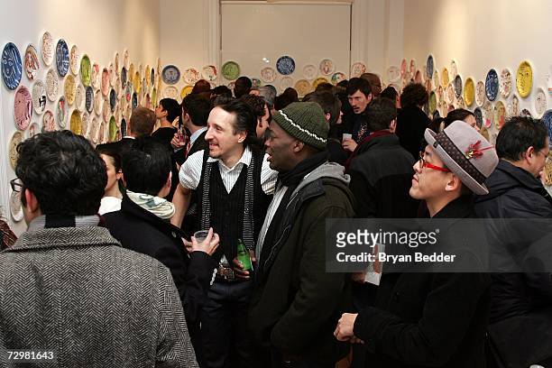 Gallery goers attend the "A Piece of Fulvimari" opening reception for artist Jeffrey Fulvimari at Gallery Hanahou on January 11, 2006 in New York...