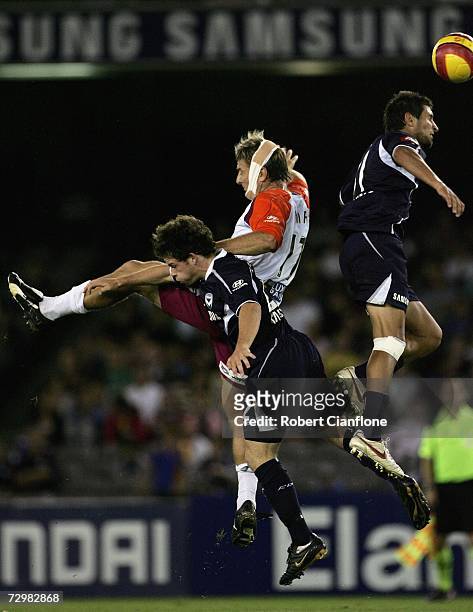Damien Mori of the Roar is challenged by Leigh Broxham and Vince Lia of the Victory during the round 20 Hyundai A-League match between the Melbourne...