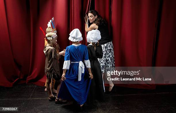 four children (7-9) with teacher waiting behind theatre curtains - acting stock pictures, royalty-free photos & images