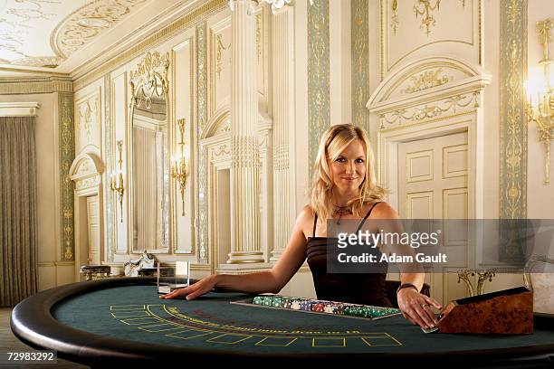 female croupier at blackjack table in casino, portrait - casino dealer stockfoto's en -beelden