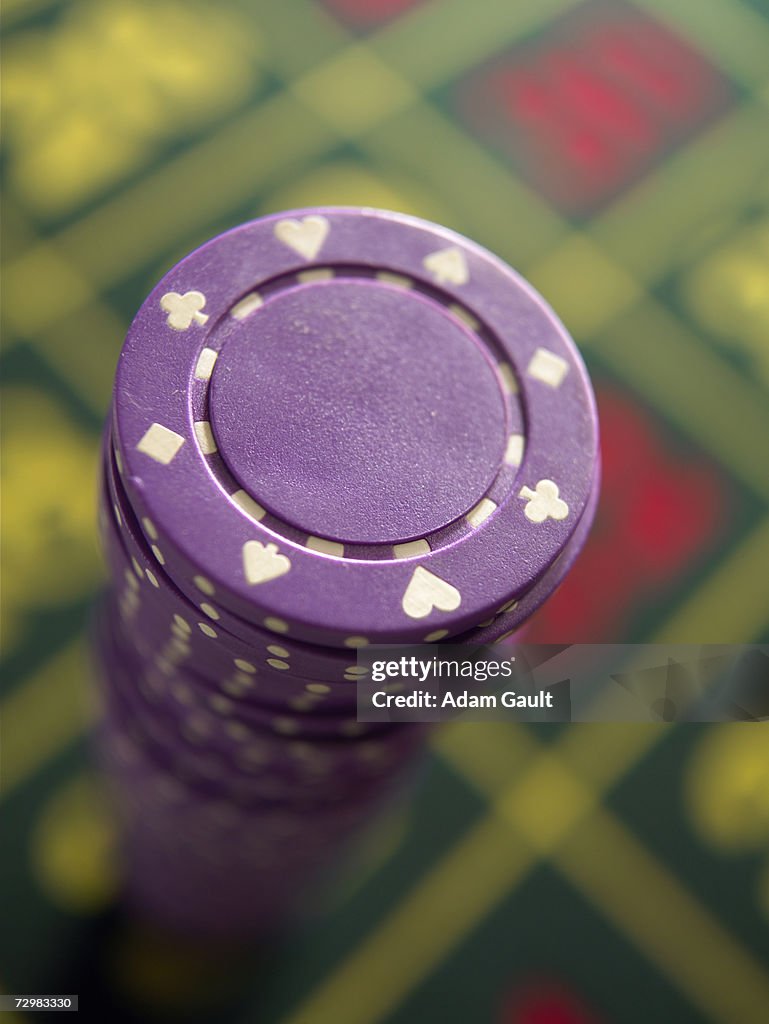 Gambling chips stacked on Roulette table, close-up, elevated view