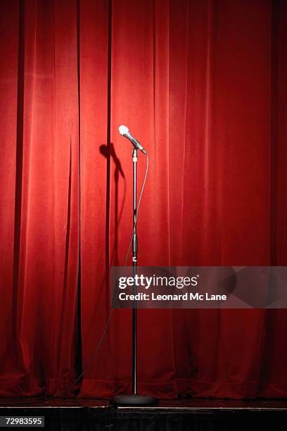 microphone on stage against red curtain - stage microphone stock pictures, royalty-free photos & images