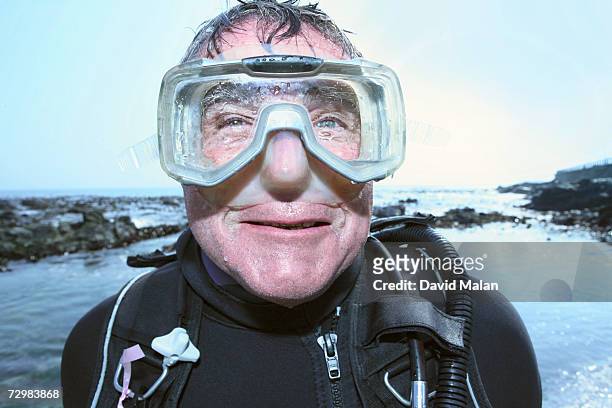 senior man in diving goggles by sea, portrait - dykmask bildbanksfoton och bilder