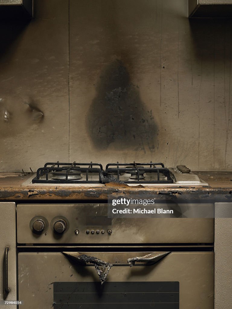 Smoke stained cooker in kitchen after fire