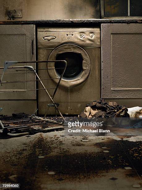 fire damaged kitchen with washing machine and upturned clothes horse - damaged stock pictures, royalty-free photos & images
