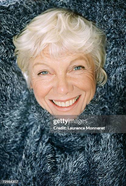 senior woman wearing pullover, smiling, portrait - umgeben stock-fotos und bilder