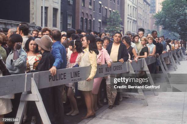 Fans crowd the police barricades along 81st Street in Manhattan to view the body of the late actress-singer Judy Garland at the Frank E. Campbell...