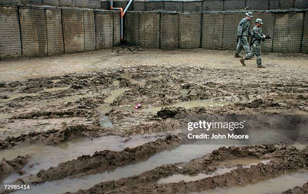 American soldiers skirt a quagmire of mud January 12, 2007 in Anbar province, Ramadi, Iraq. U.S. President George W. Bush announced this week that...