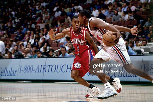 Allen Iverson of the Philadelphia 76ers digs in on defense against the Los Angeles Clippers during a 1997 NBA game at the Los Angeles Memorial Sports...