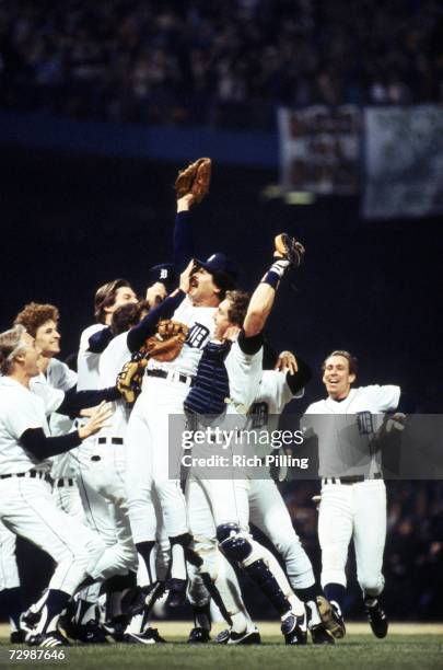 Picher Willie Hernandez and catcher Lance Parrish of the Detroit Tigers celebrate with their teammates after closing game five to win the 1984 World...